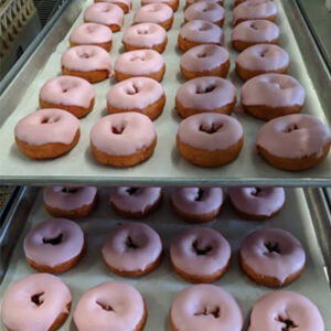 Trays of strawberry-glazed donuts